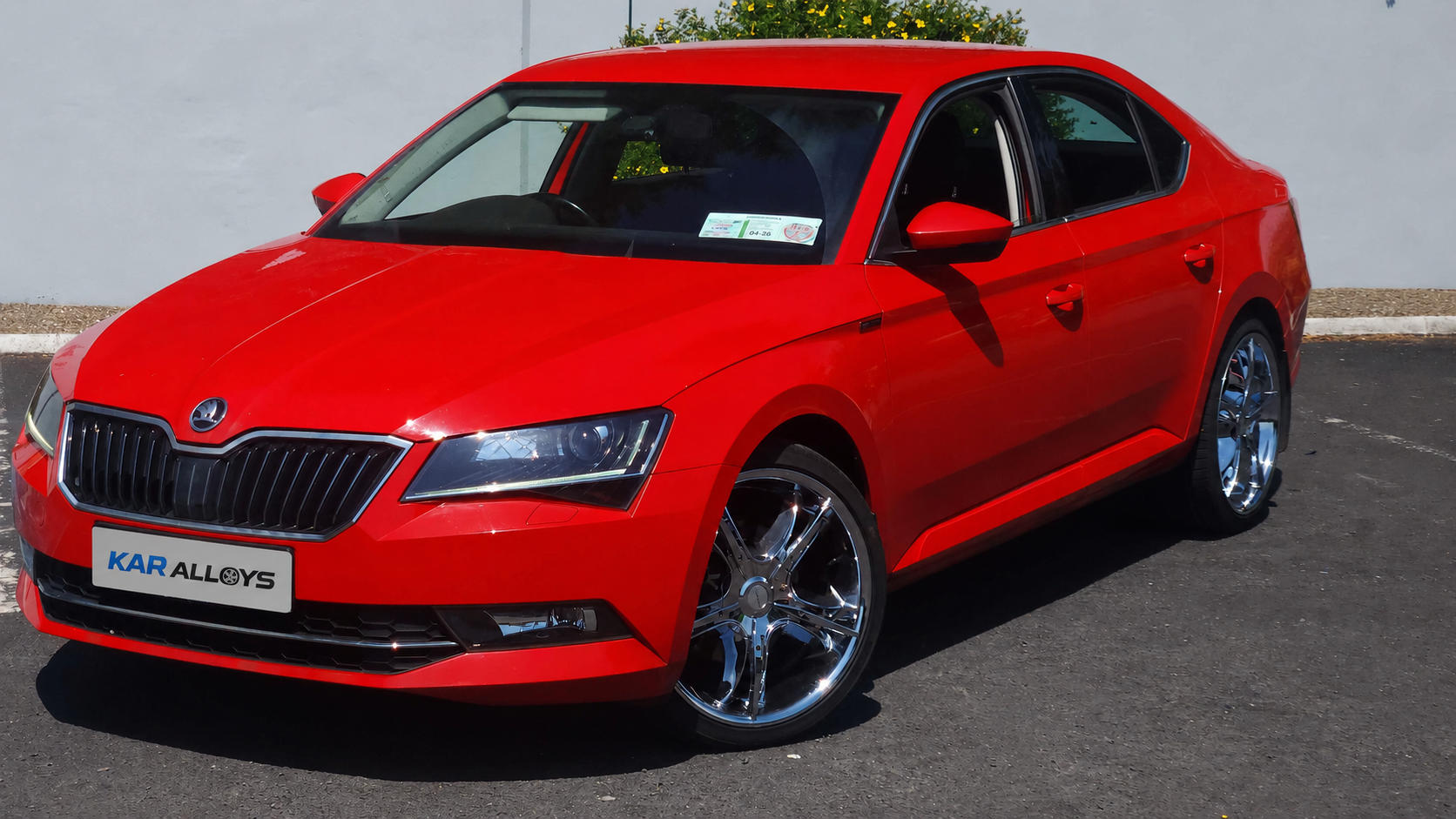 Red Škoda Superb KAR Alloys flagship car with chrome alloy wheels